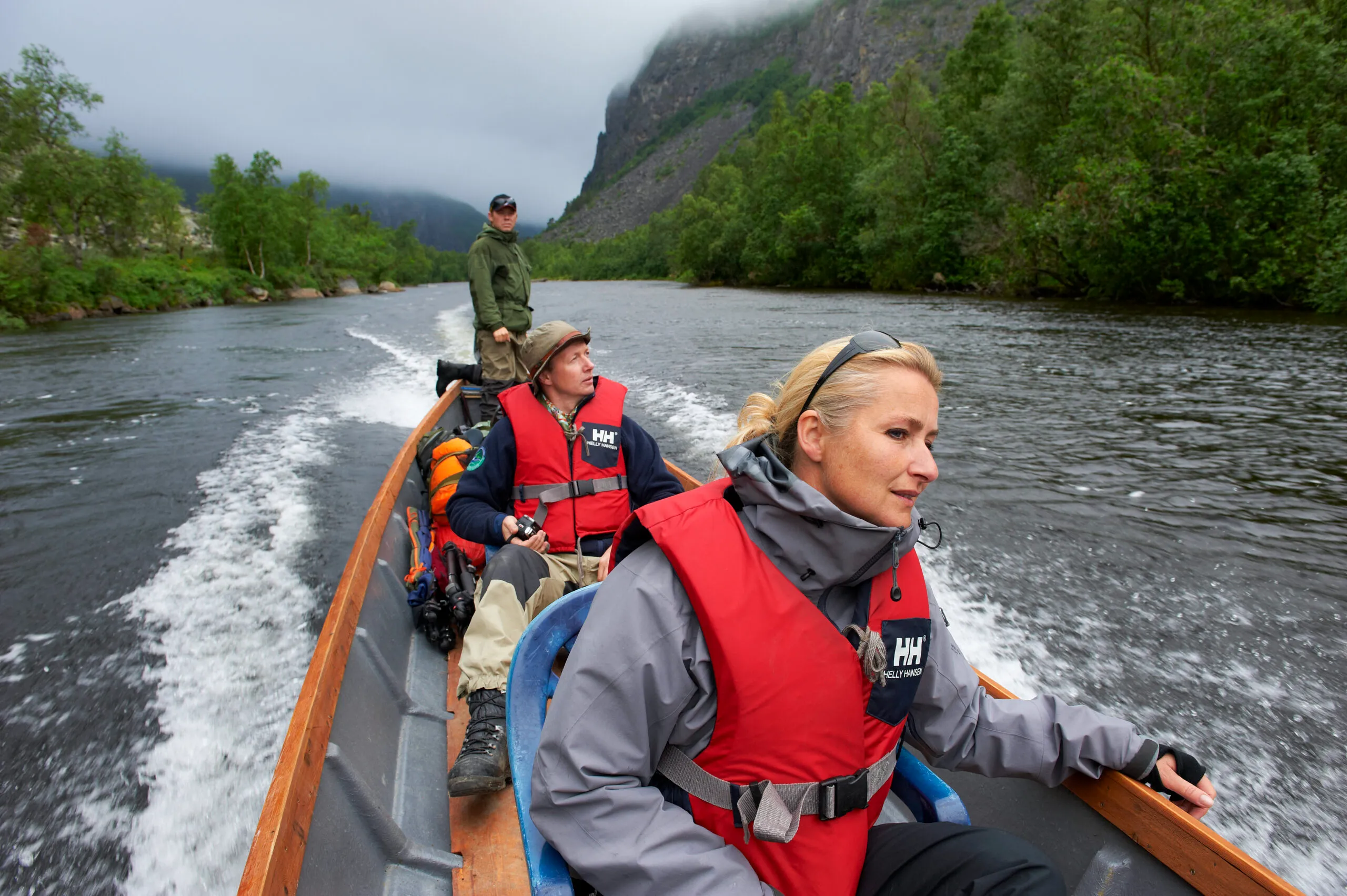 A picture of man and woman with a guide on a boat tour of Reisa National Park.