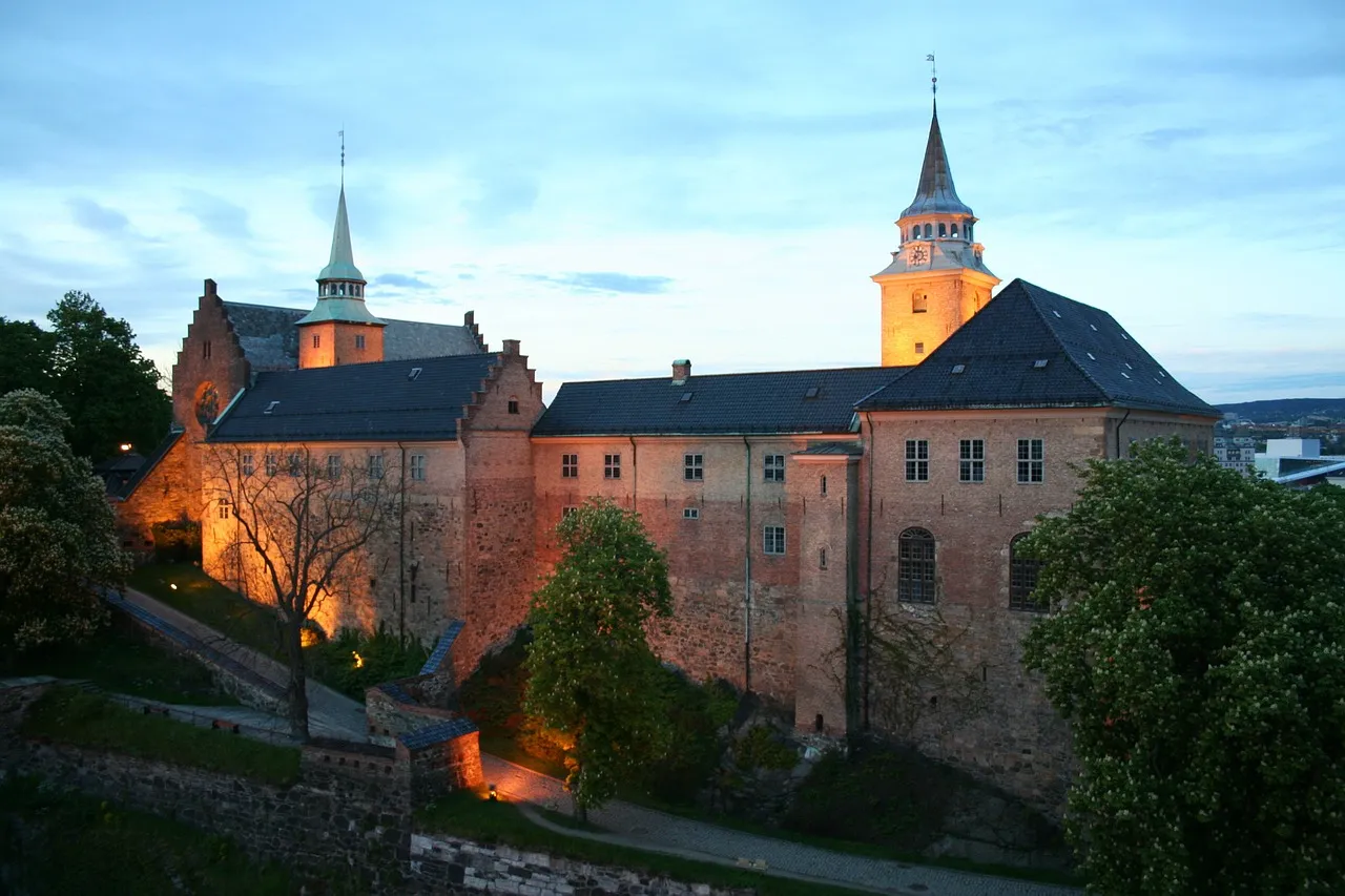 Akershus Fortress in Oslo, Norway, a medieval castle situated on a hill overlooking the harbour, showcasing its impressive stone walls, towers, and battlements.